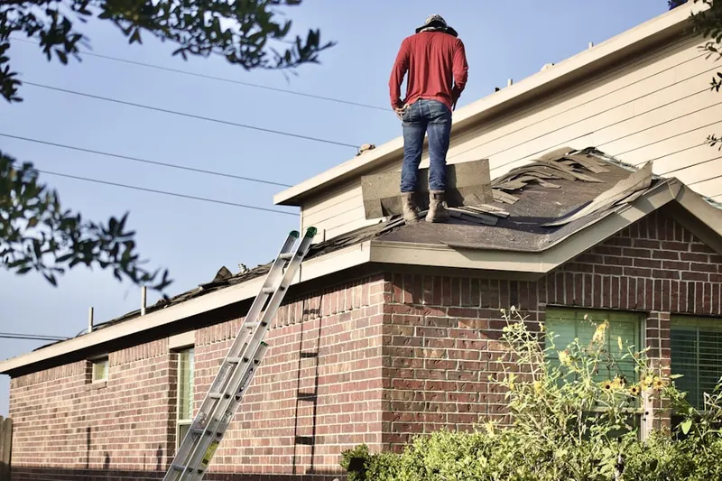Professional roofer working on a residential roof in Lakeville